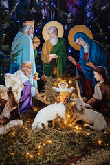 Wall Mural - Nativity scene with hand-painted wooden figures. Christmas decoration in the church.