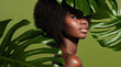 © Beauty Agent Studio - Natural cosmetics. Green beauty portrait of a young beautiful African American woman posing against green exotic plants background. Natural skin care concept