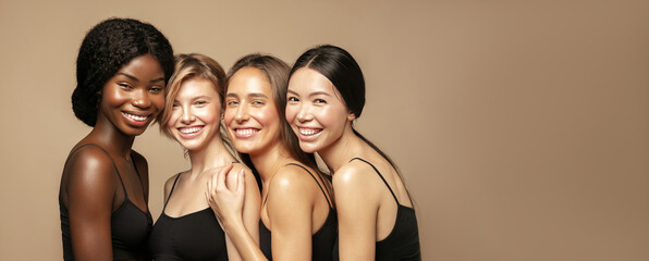 Wall Mural - beuaty portrait of multi ethnic group of womans with diffrent types of skin standing together and lo