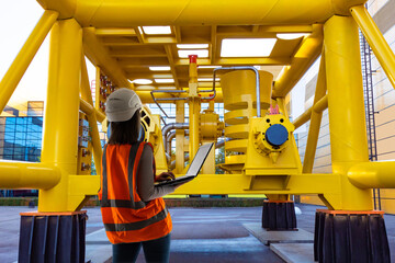 Poster - gas company. woman engineer at compressor station. girl with laptop with her back to camera. woman e