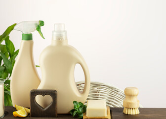 Canvas Print - Natural cleaners, cleaning products, natural detergent bottles with soap and lemon slices on wooden shelf on light background with copy space. Mockup for natural detergents and cleaning products