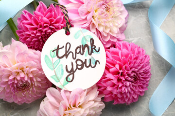 Wall Mural - Paper tag with phrase Thank You and dahlias on marble table, flat lay