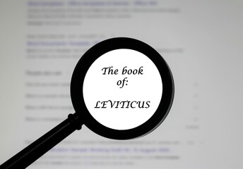  The Book of Leviticus from the Holy Bible, illustrated inside a magnifying class, zoomed in.