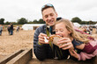 © Cavan Images - dad enjoying street food with his daughter steeling his food