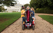 © Cavan Images - disabled grandma on a mobility scooter with her grandchildren outdoors