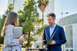 © Cavan Images - Teamwork in a business meeting in front of office building