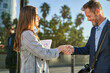 © Cavan Images - Business people dressed in formal wear shaking hands