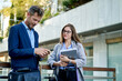 © Cavan Images - A business man and woman are discussing a presentation