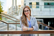 © Cavan Images - businesswoman in front of office building