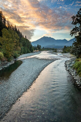 Wall Mural - scenic view of a river and mountains at sunrise