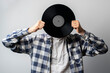 © Mihail - holding a vinyl record disc in front of head