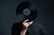© Mihail - holding a vinyl record disc in front of head
