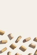 Creative Pattern With Wine Corks On Beige Background With Hard Light And Shadows At Sunlight. Minimal Style Layout With Bottle Stoppers From Red White Wine, Top View, Wine List Backdrop
