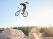 © Michael C/peopleimages.com - Bike, man and extreme jump at park, safety gear and outdoor for rush, competition and training for stunt. Bicycle, male athlete or dirt bike practice for fitness, contest or motivation for tournament
