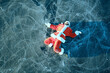 Santa Claus skating on the ice of the lake, slipped, lies down, Santa loser