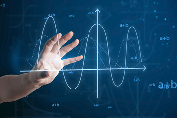 Close up of man hand pointing at abstract glowing mathematical formula graph on blue background. Equation, digital data and mathematics app concept.
