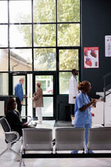 Wall Mural - People standing in hospital waiting area during checkup visit appointment, medical staff preparing to start medical consultation with sick patients. Health care service and concept