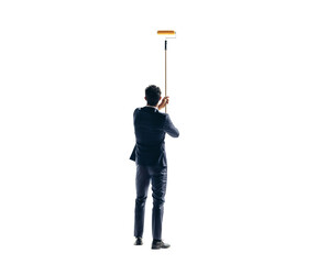 Wall Mural - Rearview of a business man painting a wall with a roller on a transparent background