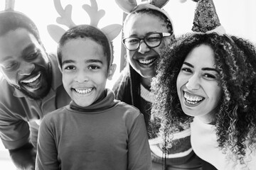 Wall Mural - African family celebrate Christmas together - Focus on kid face - Black and white editing