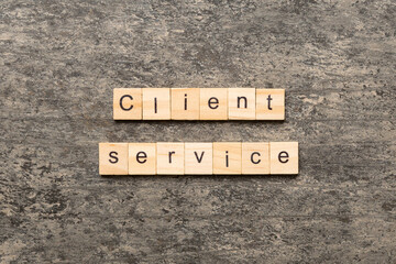 Client service word written on wood block. Client service text on cement table for your desing, concept