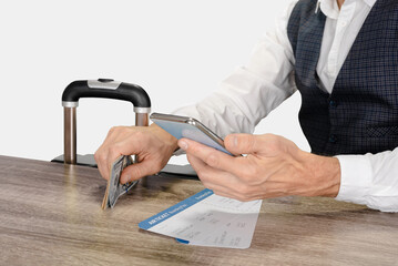 Wall Mural - Male passenger with luggage, money, tickets and smartphone traveling on weekend, on a light gray studio background