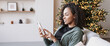 Leinwandbild Motiv Young woman using smartphone at home during Christmas holiday, Student girl texting on mobile phone banner, Connection, online shopping, winter lifestyle concept