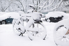 Winter In A City, Street Covered By Snow, Beautiful  Snowy Winter Scene On Town With Bicycles And Cars Covered By Snow