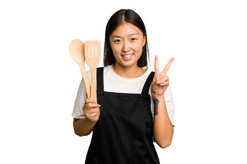 Wall Mural - Young asian cook woman isolated showing number two with fingers.