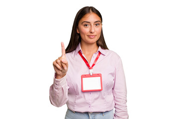 Young caucasian woman with a badge isolated showing number one with finger.