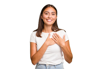 Wall Mural - Young cute caucasian woman isolated has friendly expression, pressing palm to chest. Love concept.