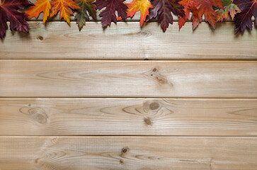 Wall Mural - Layout with autumn leaves on wooden background. Flatlay. Copyspace for text.  Autumn songs and quotes.  Maple leaves on light table. Top view. Copy place for inscription. Autumn mood concept.