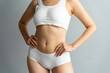© crizzystudio - Cropped image of sexy attractive young woman in white underwear showing fit body standing posing hold hand on hips legs isolated on white wall background studio portrait