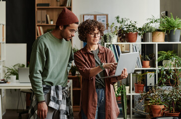 Poster - Young confident businesswoman making presentation of online information that they can use for new project to coworker