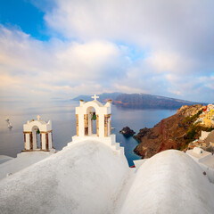 Wall Mural - Santorini, Greece. Conceptual composition of the famous architecture of the island of Santorini. White arches of bells and blue sea view. Santorini island, Greece, Europe.