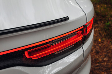 Wall Mural - Modern car rear taillight lamp close up view. Clean trunk of modern SUV car