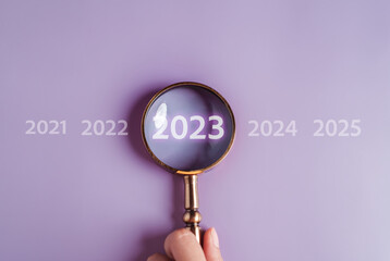 Aufkleber - Target business on 2023 year concept. Magnifier focus to 2023 icon. planning project, invest, innovation, idea to next year from end 2022, New year concept.