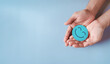 © Kiattisak - Hands holding blue happy smile face, good feedback rating, positive customer review, experience, satisfaction survey, smiley mental health, child wellness, world mental health day on blue background