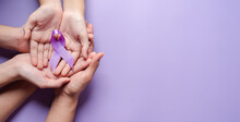 Hands Holding Purple Ribbons, Alzheimer's Disease, Pancreatic Cancer, Epilepsy Awareness, World Cancer Day On A Purple Colored Background, World Cancer Day Concept