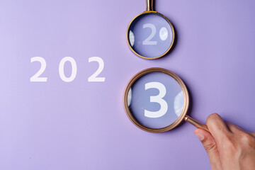 Aufkleber - Target business on 2023 year concept. Magnifier focus to 2023 icon. planning project, invest, innovation, idea to next year from end 2022, New year concept.