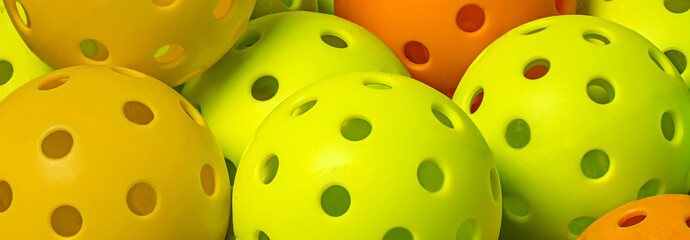 Colorful group on Pickleballs.  Yellow. Orange and green