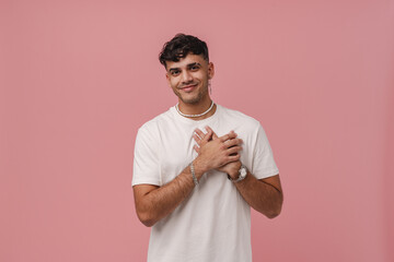 Wall Mural - Young handsome stylish smiling man with folded hands on chest