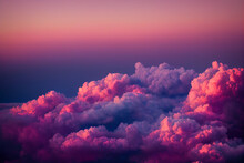 Colorful Pink And Purple Clouds At Sunset As Seen From An Airplane Window
