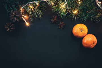christmas background with christmas tree branches and garland, flat lay.