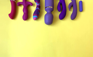 Wall Mural - Purple sex toys. Sex shop assortment. Seven vibrators on yellow background