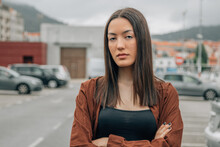 Portrait Of Serious Asian Girl Outdoors Looking At Camera