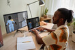 © Seventyfour - Side view of creative black man building digital 3D models at home office workplace