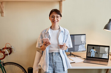 Wall Mural - Waist up portrait of creative young woman as digital 3D designer smiling at camera by workplace , copy space