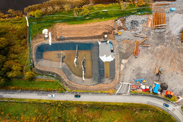 Construction site with heavy machinery, Aerial top down view. Building industry. Development area for commercial or residential property.