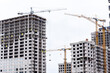 Crane tower at the construction site of a multi-storey residential building. Building concept