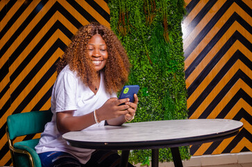 Wall Mural - close up of a Beautiful cute young woman in the cafe, using mobile phone